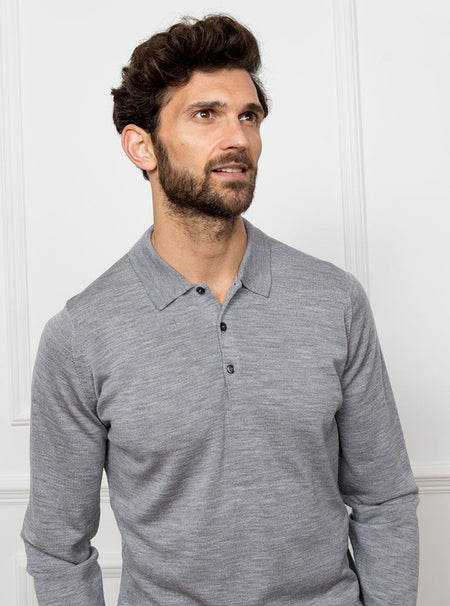 Man wearing silver grey long sleeved polo neck sweater knit in 100% luxury and premium merino wool.
